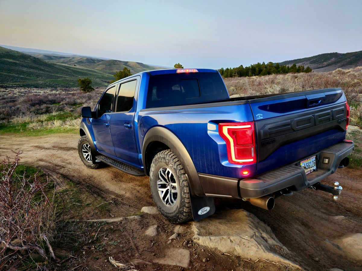 Blue truck off-roading on a dirt trail